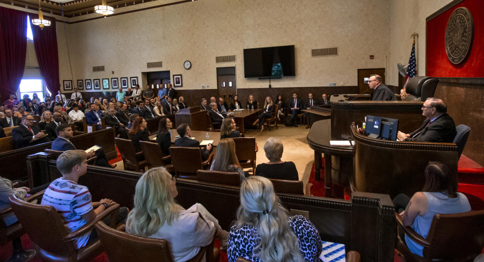 Judge Thad Balkman reads a summary of his decision to a full courtroom during the opioid trial at the Cleveland County Courthouse in Norman, Okla., Monday, Aug. 26, 2019. Balkman ruled in favor of the state of Oklahoma and ordered Johnson and Johnson to pay $572 million to a plan to abate the opioid crisis. (Chris Landsberger/The Oklahoman via AP, Pool)