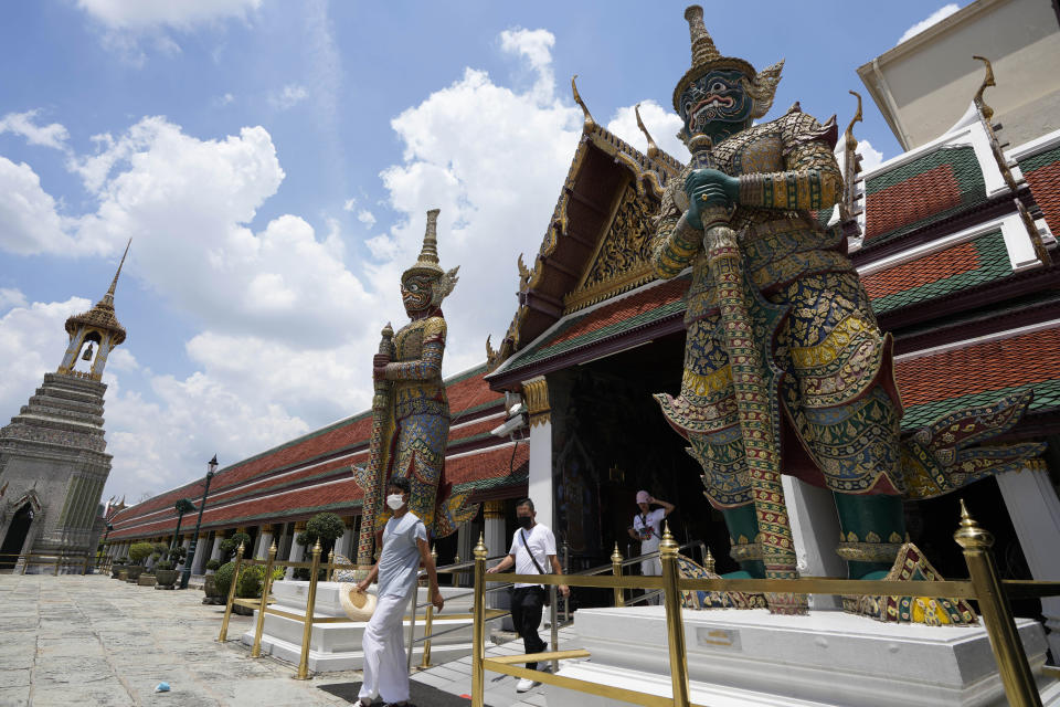 Tourists visit Grand Palace in Bangkok, Thailand, Friday, June 17, 2022. Summer travel is underway across the globe, but a full recovery from two years of coronavirus could last as long as the pandemic itself. (AP Photo/Sakchai Lalit)
