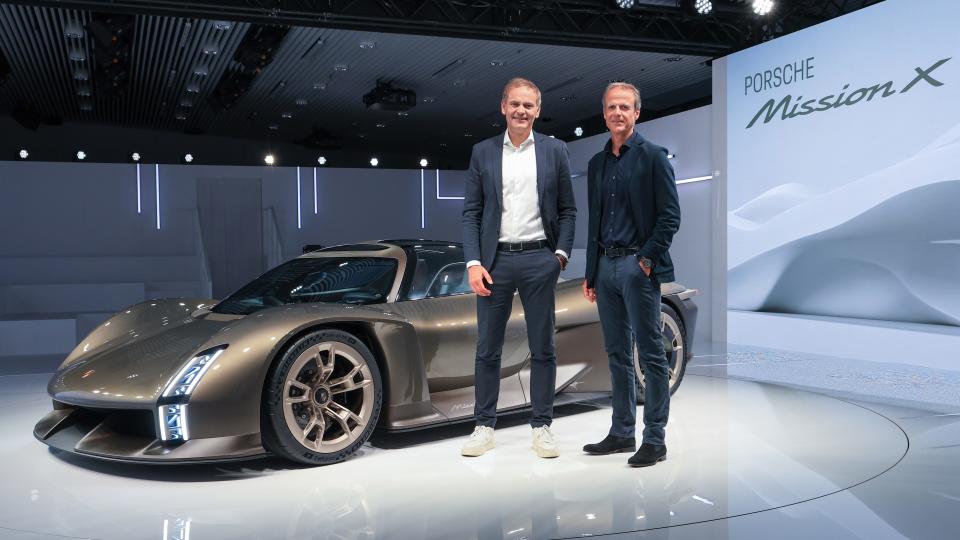 Oliver Blume and Michael Mauer pose in front of Porsche Mission X