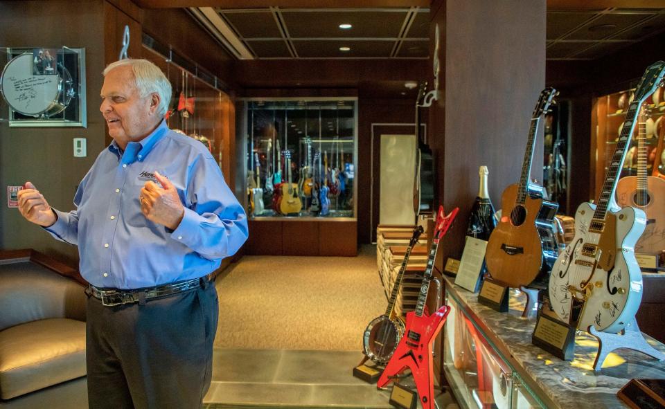 Rick Hendrick talks inside of the second-floor room where dozens of signed guitars and photographs and other memorabilia are on display inside the 58,000-square foot Heritage Center in Concord, North Carolina, on July 25, 2023.