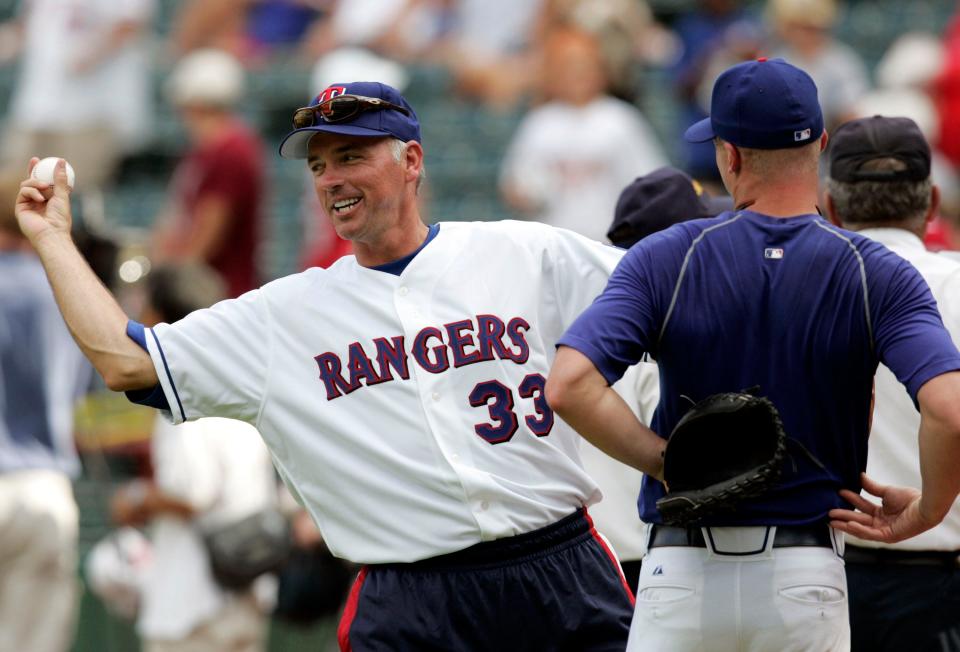 Former Texas Rangers pitcher John Burkett (33) jokes around with current Rangers pitcher Ron Mahay, right, prior to the start of a Rangers alumni legacy baseball game in Arlington, Texas, Friday, Aug. 11, 2006. Burkett played with the Rangers from 1996-1999. (AP Photo/Tony Gutierrez)