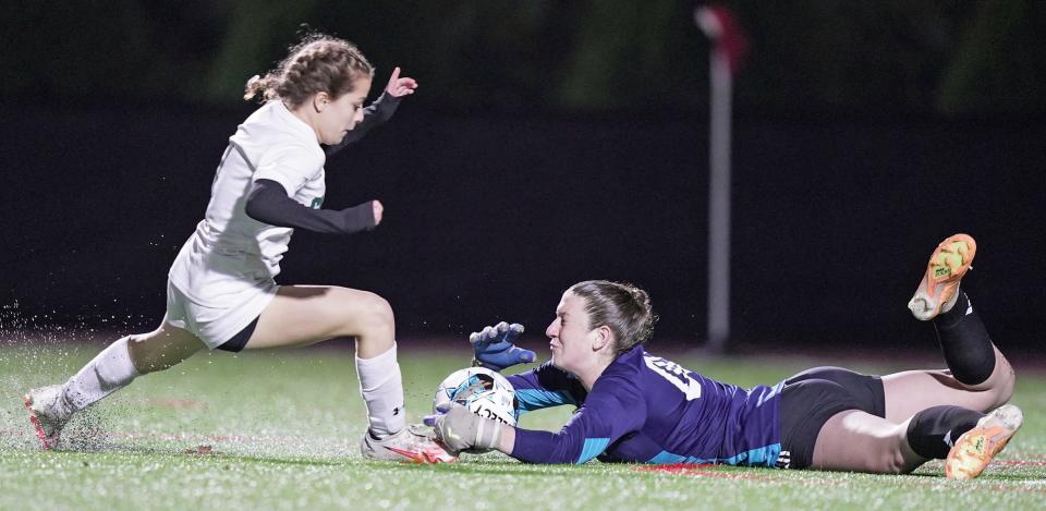Mt. Hope goalie Emily Moran covers the ball before Chariho's Lily Vazquez-Bolton can make a play on it during the second half of Tuesday's RIIL Girls Soccer Semifinal at Rhode Island College.