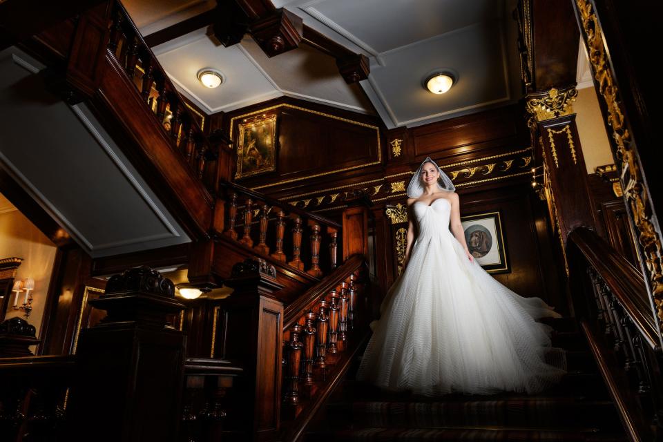 Descending the stairs in custom Zac Posen.