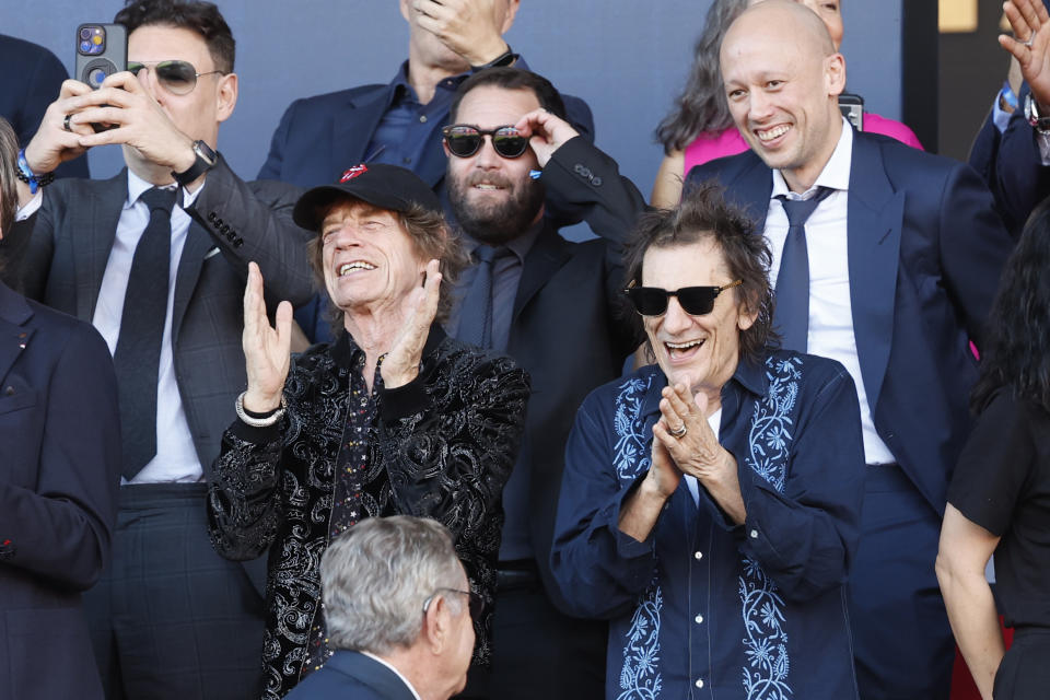 Mick Jagger, centre left, and Ronnie Wood, right, of the band "The Rolling Stones," seen prior to the La Liga soccer match between Barcelona and Real Madrid at the Olympic Stadium in Barcelona, Spain, Saturday, Oct. 28, 2023. (AP Photo/Joan Monfort)