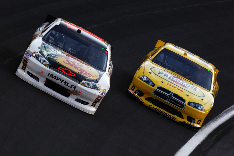 CHARLOTTE, NC - MAY 19: Jamie McMurray, driver of the #1 Bass Pro Shops/Allstate Chevrolet, and AJ Allmendinger, driver of the #22 Pennzoil Dodge, race during the NASCAR Sprint Showdown at Charlotte Motor Speedway on May 19, 2012 in Charlotte, North Carolina. (Photo by Jeff Zelevansky/Getty Images for NASCAR)