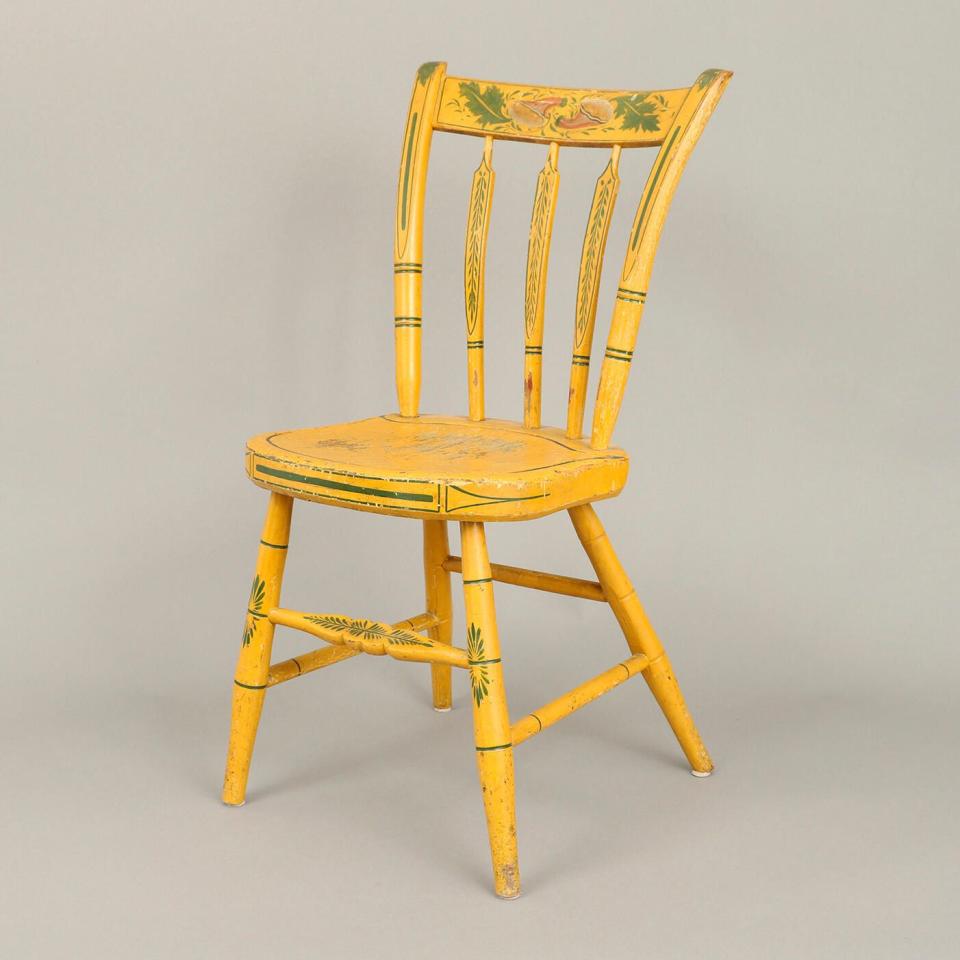 a yellow chair with a cushion