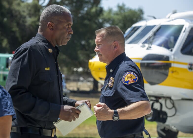 LA CANADA/FLINTRIDGE, CA-JUNE 9, 2022: Los Angeles County Fire Chief Daryl L. Osby left, gives a fist bump to Brian Marshall, Chief of Fire & Rescue California Governor's Office of Emergency Services during a press conference at Los Angeles County Fire Department Fire Camp 2 in La Canada/Flintridge to discuss the outlook on the 2022 fire season amid extreme drought conditions throughout California. (Mel Melcon / Los Angeles Times)