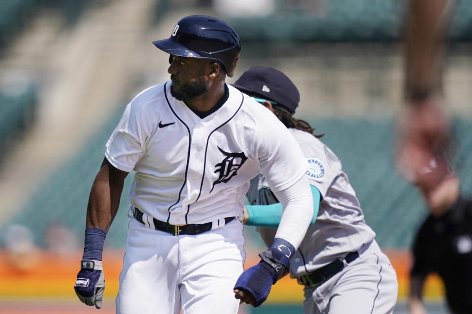 Detroit Tigers' Niko Goodrum is tagged by Seattle Mariners shortstop J.P. Crawford in a rundown between first and second during the seventh inning of a baseball game, Thursday, June 10, 2021, in Detroit. (AP Photo/Carlos Osorio)