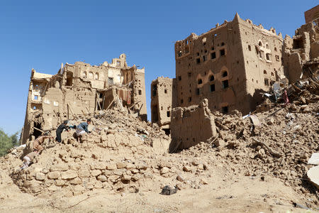 FILE PHOTO: Boys walk amid ruins of houses during the conflict in the northwestern city of Saada, Yemen November 22, 2018. Picture taken November 22, 2018. REUTERS/Naif Rahma/File Photo