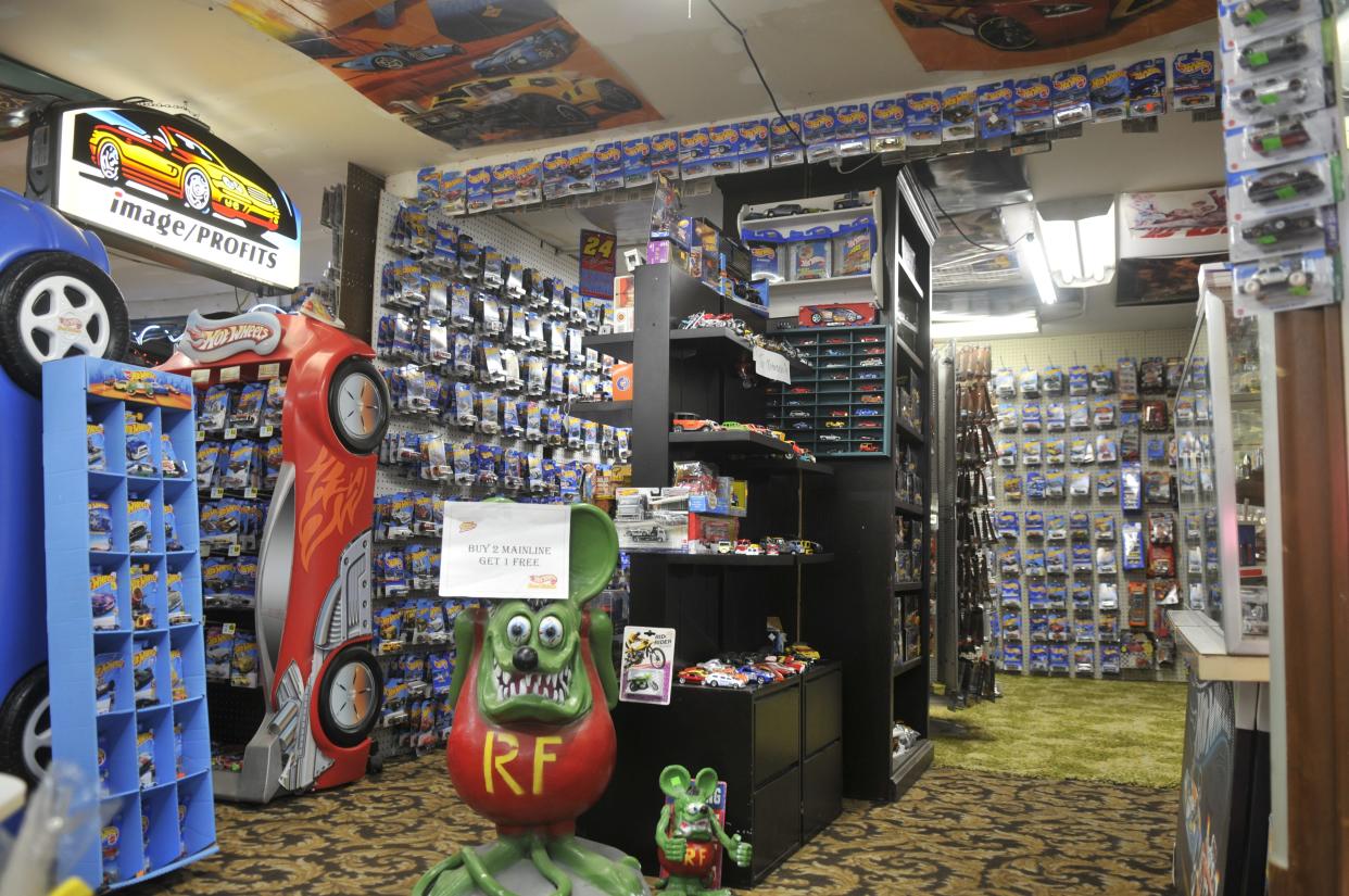 Hot Rod Rat Fink statue and a large collection of Hot Wheels welcome customers when they walk into Booth 202.