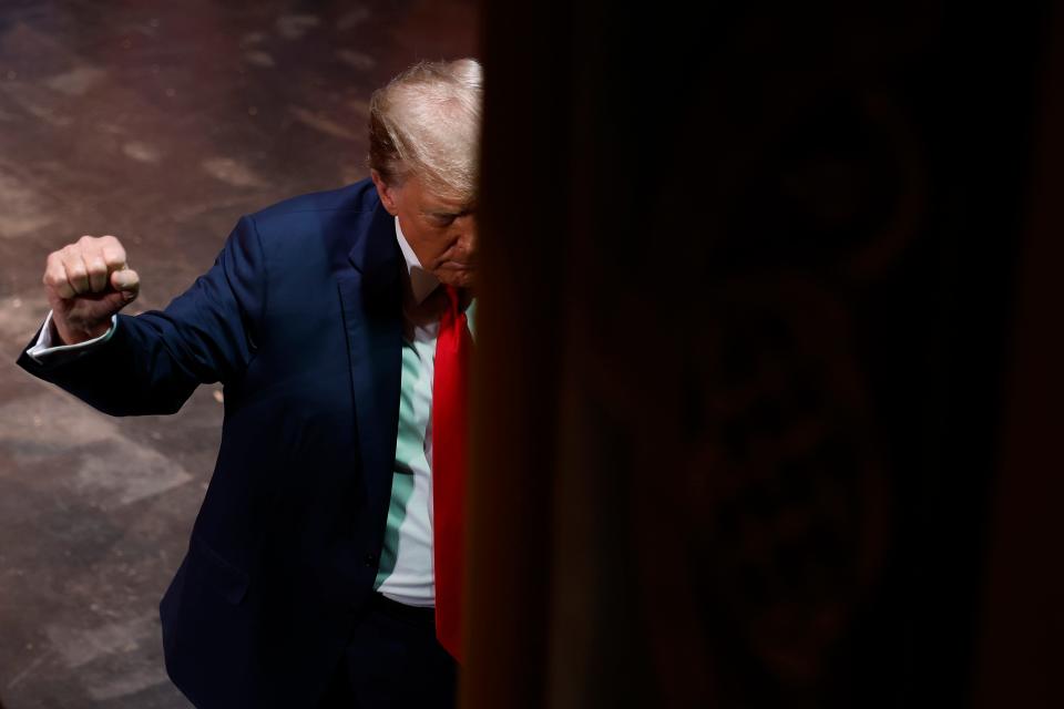 Republican presidential candidate and former President Donald Trump pumps his fist as he walks off the stage after a campaign rally at the Rochester Opera House on January 21, 2024 in Rochester, New Hampshire.