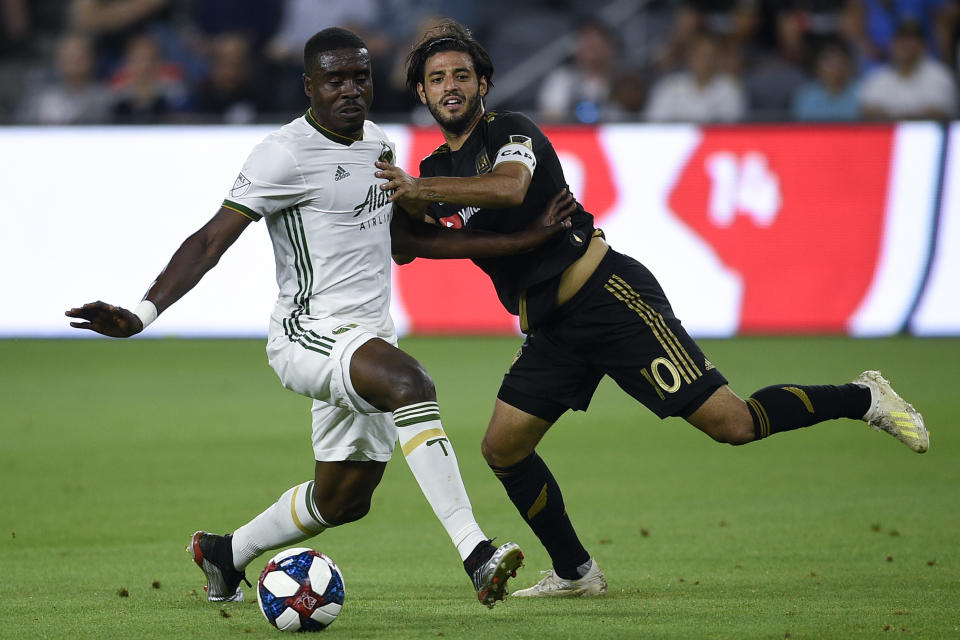 Jul 10, 2019; Los Angeles, CA, USA; Portland Timbers defender Larrys Mabiala (33) takes the ball away from Los Angeles FC forward Carlos Vela (10)  during the first half at Banc of California Stadium. Mandatory Credit: Kelvin Kuo-USA TODAY Sports