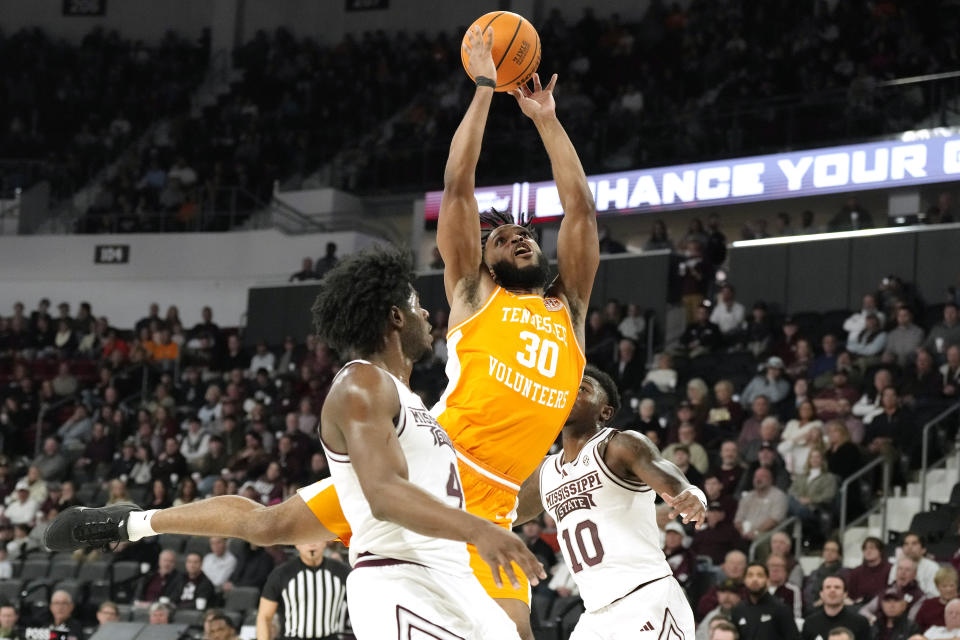 Tennessee guard Josiah-Jordan James (30) attempts a shot at the basket while defended by Mississippi State players during the first half of an NCAA college basketball game, Wednesday, Jan. 10, 2024, in Starkville, Miss. (AP Photo/Rogelio V. Solis)