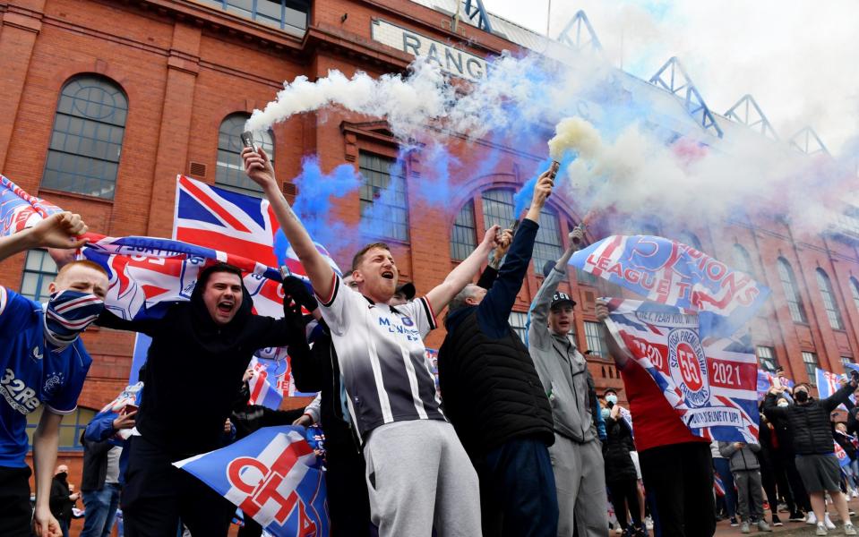 Rangers fans set off smoke bombs as they gather outside the Ibrox Stadium - Getty Images Europe