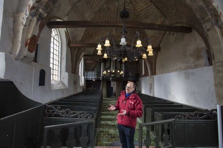 Jur Bekooy speaks to Reuters about the growing cracks in the ceiling and walls of the 13th-Century Maria Church in the village of Westerwijtwerd February 24, 2015. REUTERS/Michael Kooren