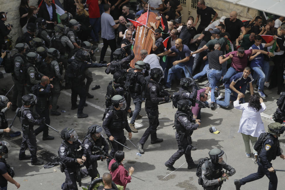 FILE - Israeli police confront mourners as they carry the casket of slain Al Jazeera veteran journalist Shireen Abu Akleh during her funeral in east Jerusalem, Friday, May 13, 2022. Latin Patriarch Pierbattista Pizzaballa, the top Catholic clergyman in the Holy Land, told reporters at St. Joseph Hospital in Jerusalem on Monday that the police beating mourners as they carried Shireen Abu Akleh's her casket was a disproportionate use of force that “disrespected” the Catholic Church. He added that Israel committed a “severe violation” of international norms. (AP Photo/Maya Levin, File)