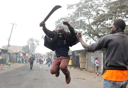 A supporter of opposition leader Raila Odinga gestures with a machete in Kibera slum in Nairobi, Kenya, August 11, 2017. REUTERS/Goran Tomasevic