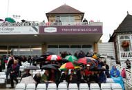 Cricket - England vs West Indies - Second One Day International - Trent Bridge, Nottingham, Britain - September 21, 2017 Fans shelter under their umbrellas as rain stops play Action Images via Reuters/Andrew Boyers
