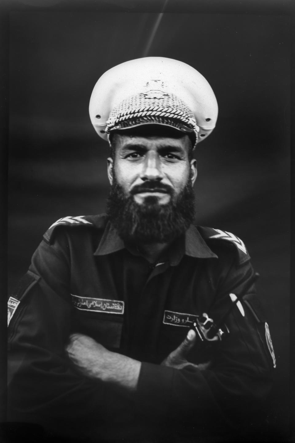 Traffic officer Muhammad Yaseen Niazi, 27, poses for a portrait in Kabul, Afghanistan, Wednesday, June 7, 2023. His monthly salary is 12,000 afghanis, around 142 U.S. dollars, and says it is not enough for him and his family. (AP Photo/Rodrigo Abd)