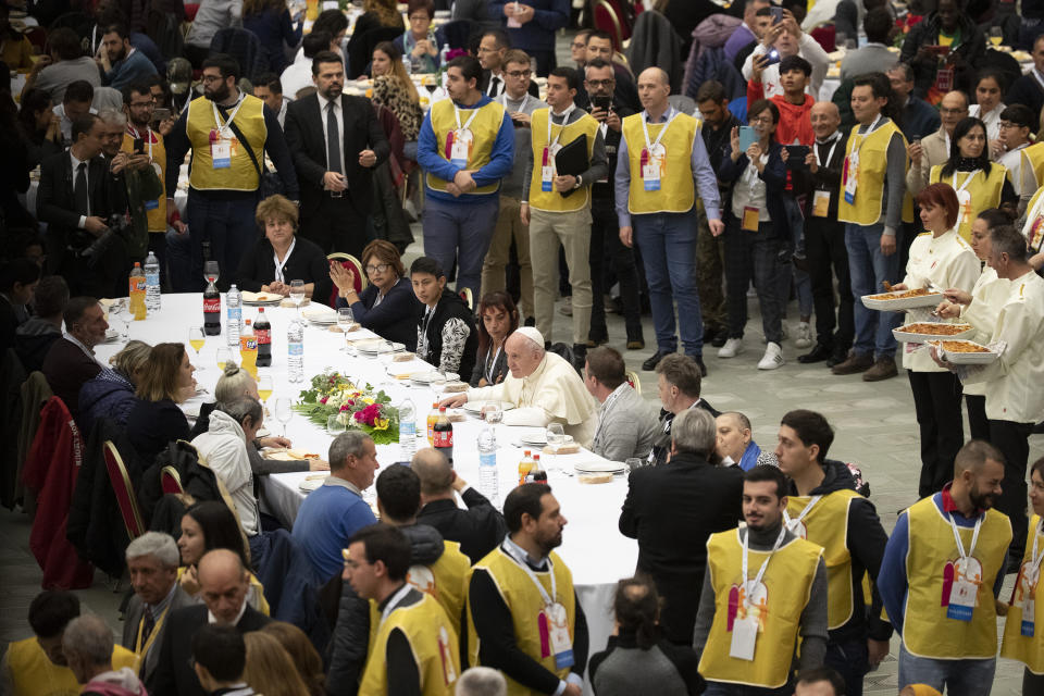 Pope Francis sits at a table during a lunch, in the Paul VI Hall at the Vatican, Sunday, Nov. 17, 2019. Pope Francis is offering several hundred poor people, homeless, migrants, unemployed, a lunch on Sunday as he celebrates the World Day of the Poor with a concrete gesture of charity in the spirit of his namesake, St. Francis of Assisi. (AP Photo/Alessandra Tarantino)