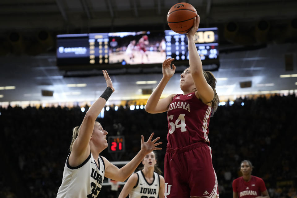 Indiana forward Mackenzie Holmes (54) shoots over Iowa forward Monika Czinano (25) during the first half of an NCAA college basketball game, Sunday, Feb. 26, 2023, in Iowa City, Iowa. (AP Photo/Charlie Neibergall)