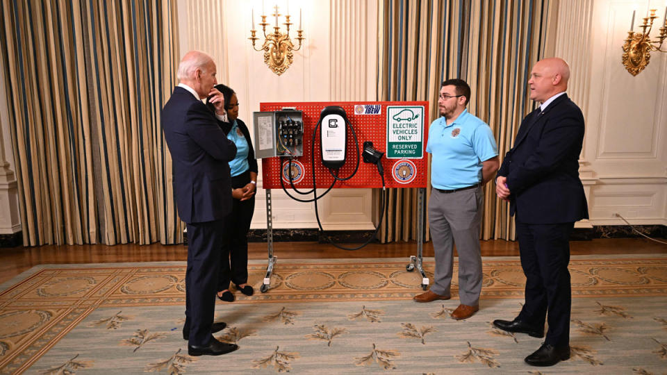 U.S. President Joe Biden gets a demonstration of an EV charging setup at the White House.