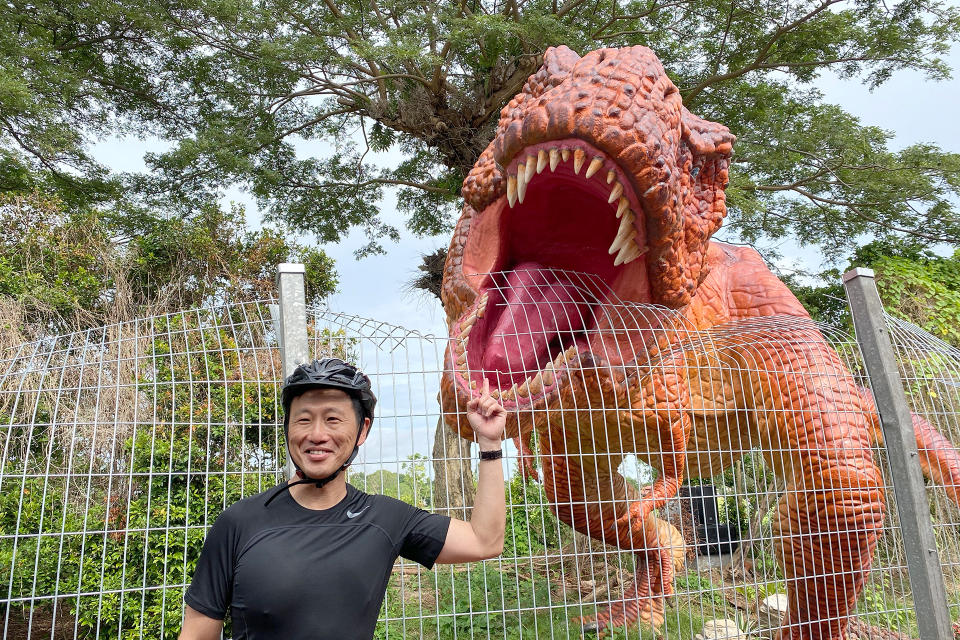 Transport Minister Ong Ye Kung, who officiated the launch of the Changi Airport Connector on Sunday (11 October), posing with a Tyrannosaurus Rex display. (PHOTO: Dhany Osman / Yahoo News Singapore)