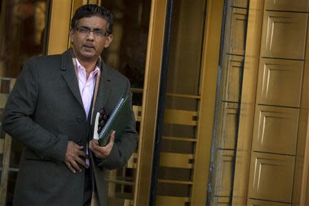 Conservative commentator and best-selling author, Dinesh D'Souza exits the Manhattan Federal Courthouse in New York, January 24, 2014. REUTERS/Brendan McDermid