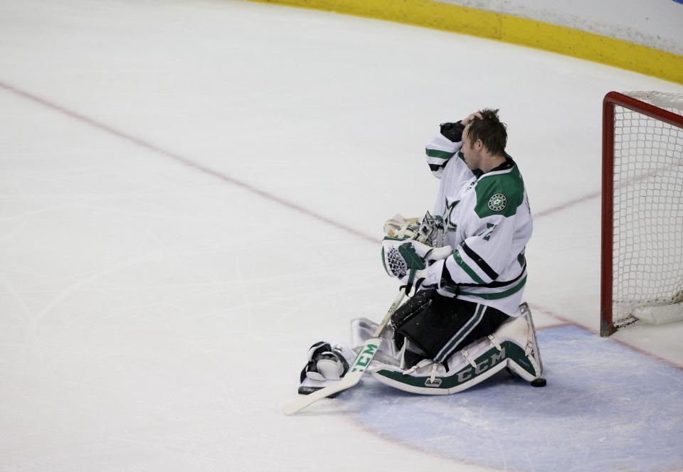 Dallas Stars goalie Kari Lehtonen, of Finland, kneels on the ice after allowing a goal by Anaheim Ducks' Ryan Getzlaf during the first period in Game 1 of the first-round NHL hockey Stanley Cup playoff series on Wednesday, April 16, 2014, in Anaheim, Calif. (AP Photo/Jae C. Hong)