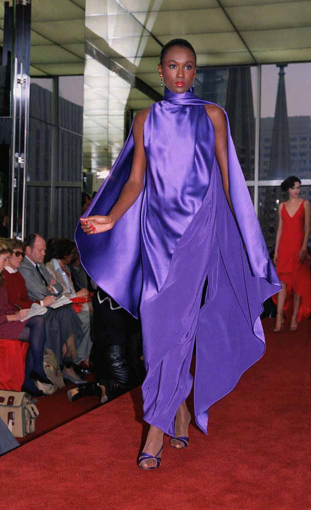 a model walks the runway in a purple halston gown in a roundup of the best of 1980s fashion for women  vintage '80s outfits and fashion trends