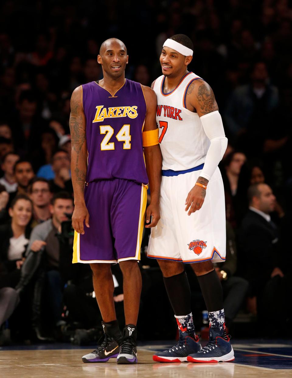 Los Angeles Lakers forward Kobe Bryant (24) chats with New York Knicks forward Carmelo Anthony (7) during a lull in play in the second half of an NBA basketball game at Madison Square Garden in New York, Sunday, Nov. 8, 2015.