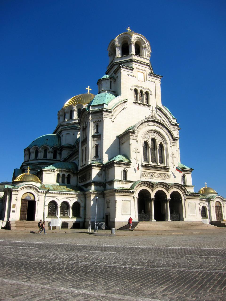 This Aug. 28, 2012 photo shows walk near Alexander Nevsky Church in Sofia, Bulgaria. The church is one of Sofia's most recognizable landmarks. A visit to Bulgaria can alternately feel like taking like a step back in time and witnessing a society that has modernized at warp speed. Mules and Ferraris share the freeways. Near a store selling Prada and Versace clothes, old women peddle handmade crocheted doilies and embroidered tablecloths. Dilapidated Soviet-style apartment buildings teem with people, as does a sparkling new shopping mall. (AP Photo/Coralie Carlson)