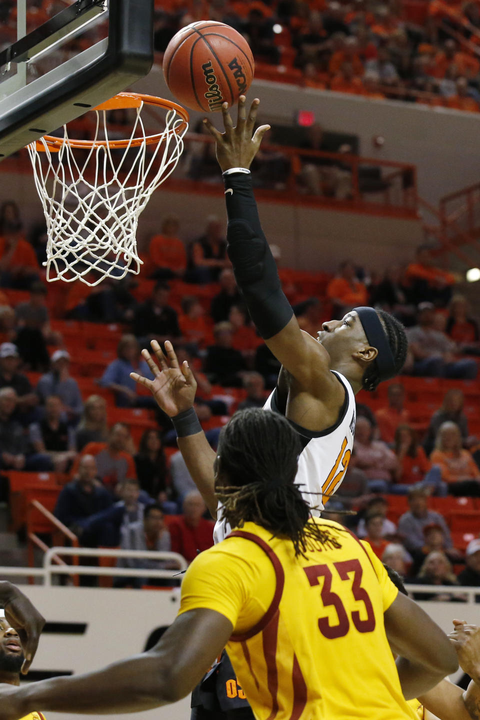 Oklahoma State forward Cameron McGriff (12) shoots in front of Iowa State forward Solomon Young (33) in the first half of an NCAA college basketball game in Stillwater, Okla., Saturday, Feb. 29, 2020. (AP Photo/Sue Ogrocki)