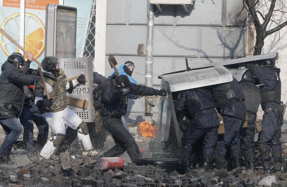 Anti-government protesters clash with riot police outside Ukraine's parliament in Kiev, Ukraine, Tuesday, Feb. 18, 2014. Thousands of angry anti-government protesters clashed with police in a new eruption of violence following new maneuvering by Russia and the European Union to gain influence over this former Soviet republic. (AP Photo/Efrem Lukatsky)