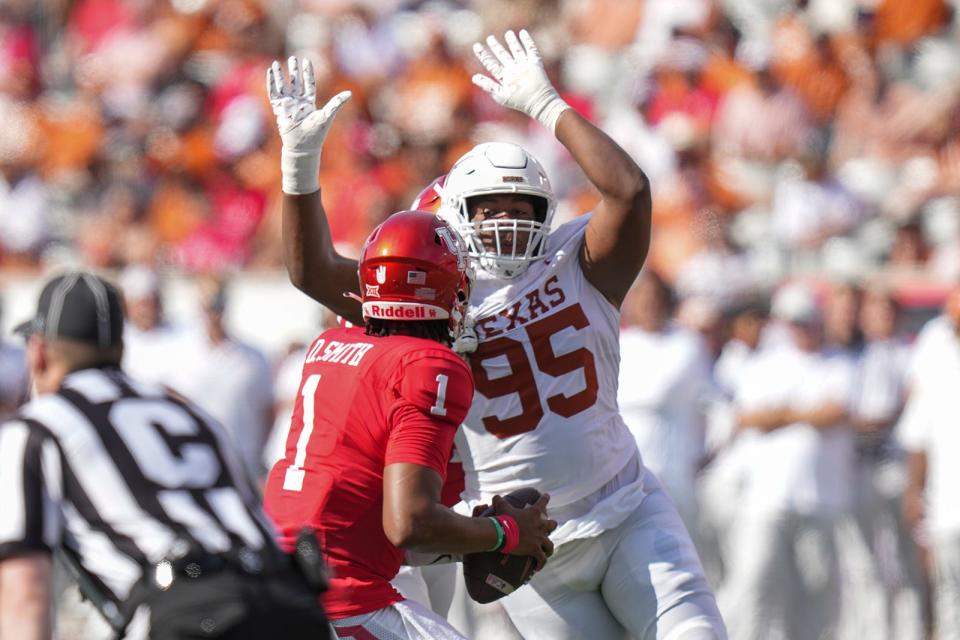 Texas defensive lineman Alfred Collins applies pressure on Houston quarterback Donovan Smith during their Oct. 21 game at Houston. With the departure of T'Vondre Sweat and Byron Murphy II, Collins is being asked to take on a bigger role this coming season for the Longhorns.