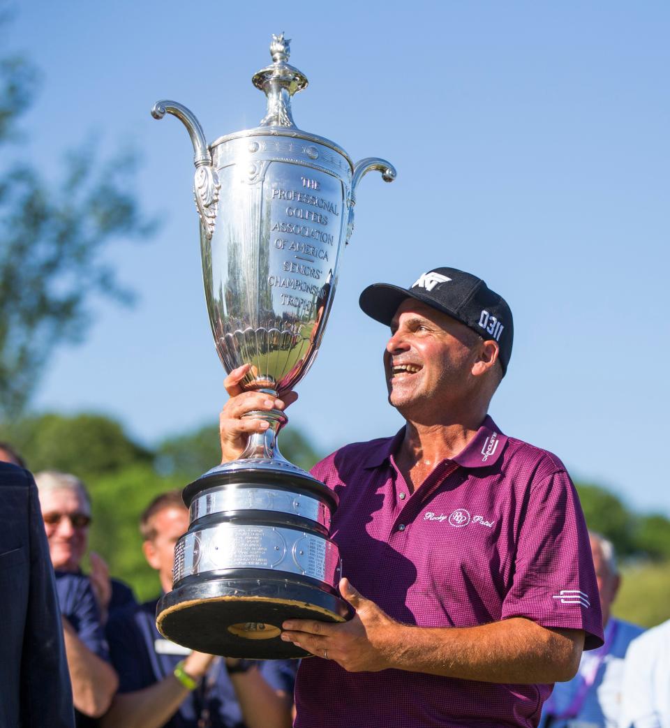 Rocco Mediate holds up the Senior PGA Championship trophy following the final round of the golf tournament at Harbor Shores Golf Club in Benton Harbor, Mich., Sunday, May 29, 2016. Rocco Mediate won with a score of 19 under.