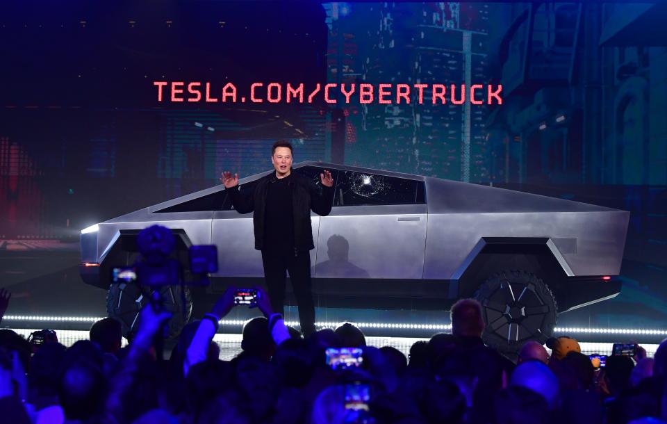 Tesla co-founder and CEO Elon Musk speaks in front of the newly unveiled all-electric battery-powered Tesla's Cybertruck with shattered windows, after a failed resistance test, at Tesla Design Center in Hawthorne, California on November 21, 2019. (Photo by FREDERIC J. BROWN / AFP) (Photo by FREDERIC J. BROWN/AFP via Getty Images)