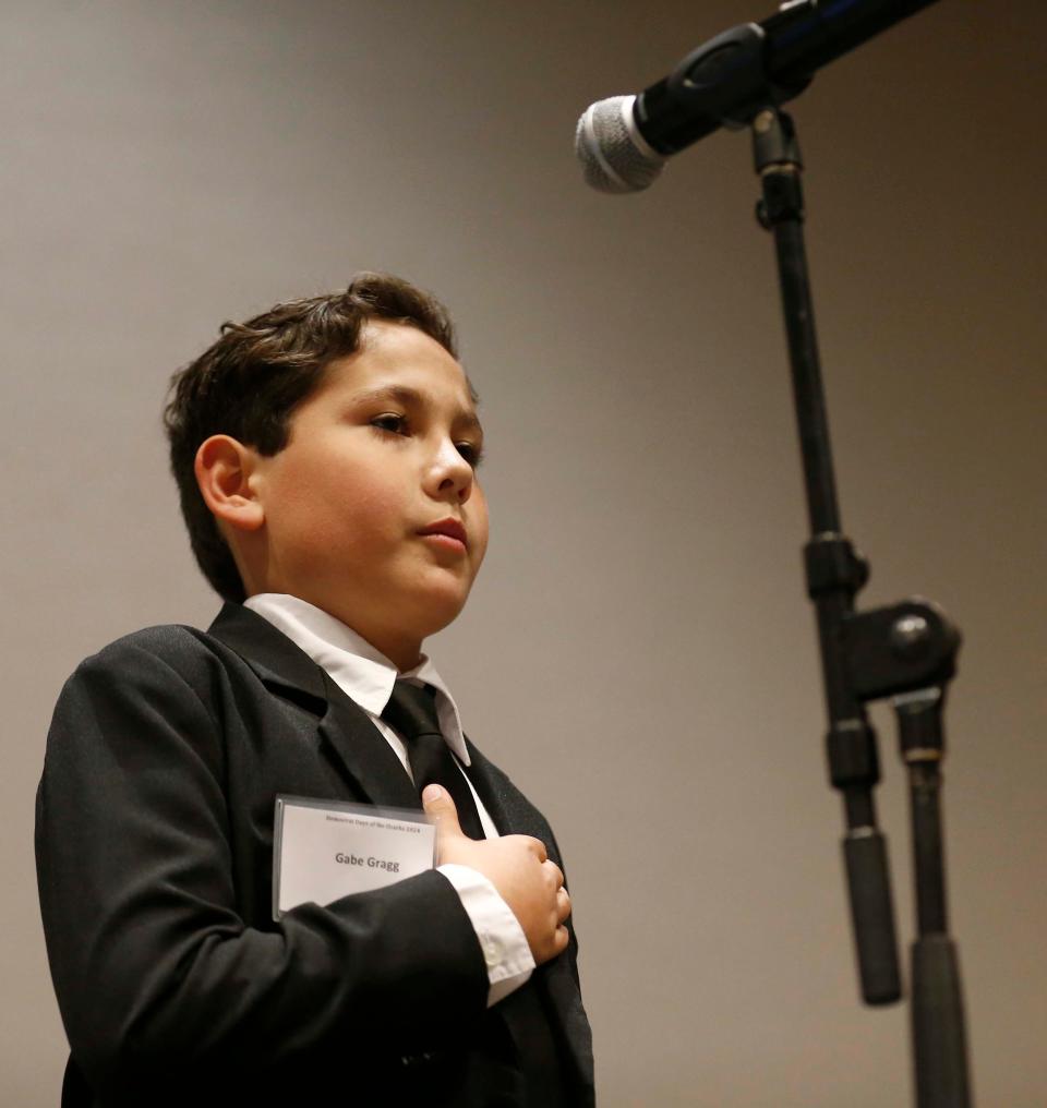 Young Gabe Gragg leads to the pledge of allegiance during the Democrat Days Banquet at the Doubletree Hotel in Springfield on April 6, 2024.