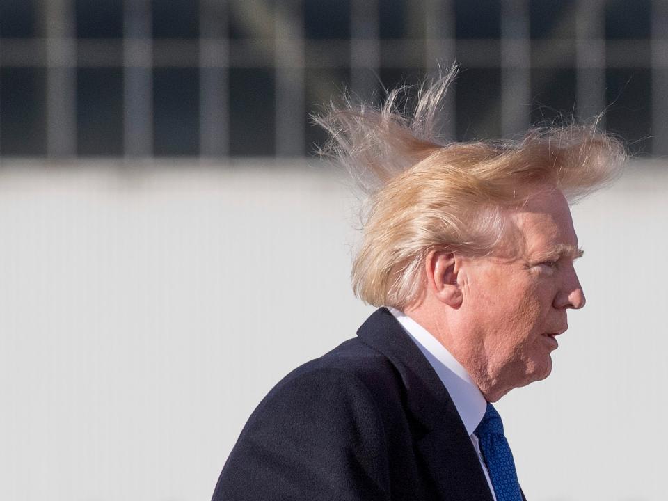 Donald Trump’s hair blows in the wind as he boards Air Force One on 10 November 2017AFP via Getty Images