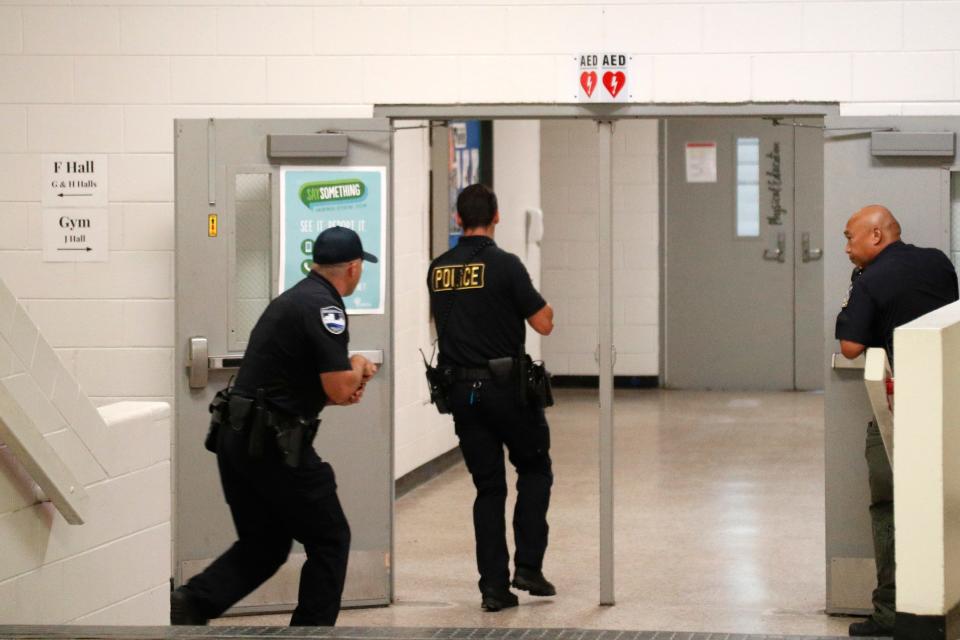 Savannah Police and a Savannah Chatham County Public Schools SRO move down the hall during an active shooter drill at the STEM Academy at Bartlett.