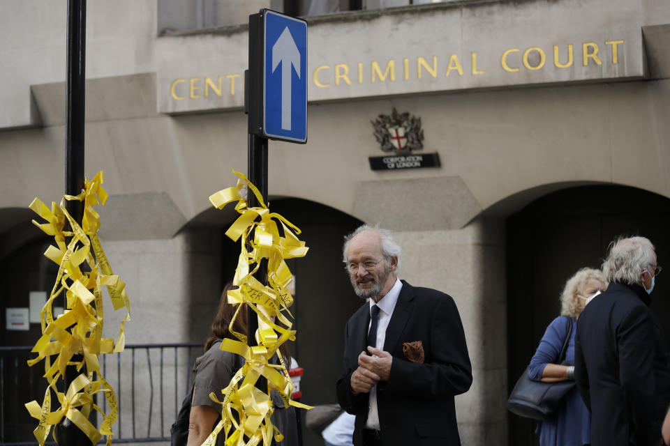 John Shipton, the father of WikiLeaks founder Julian Assange, looks at ribbons tied to a street sign by a supporter of his son outside the Central Criminal Court, the Old Bailey, in London, Monday, Sept. 14, 2020. The London court hearing on WikiLeaks founder Julian Assange's extradition from Britain to the United States resumed Monday after a COVID-19 test on one of the participating lawyers came back negative, WikiLeaks said Friday, (AP Photo/Matt Dunham)