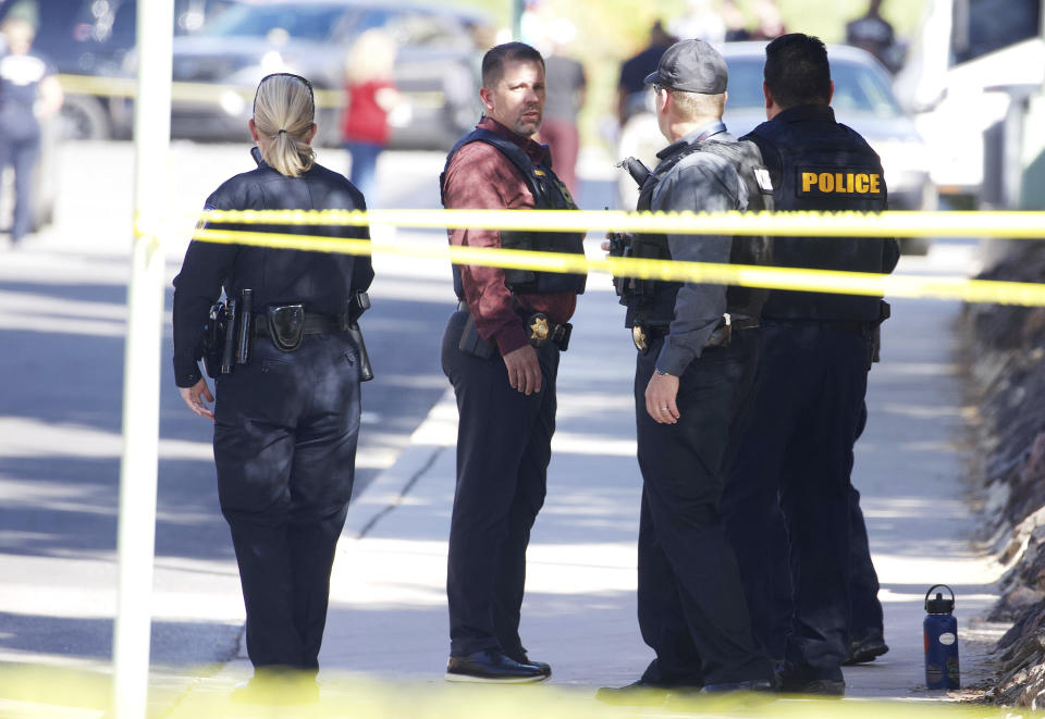 Law enforcement work at the scene of shooting at the John W. Harshbarger Building on the University of Arizona campus in Tucson, Ariz., on Wednesday, Oct. 5, 2022. University of Arizona police say one person was shot and wounded on campus and authorities are searching for the suspect. (Rebecca Sasnett/Arizona Daily Star via AP)