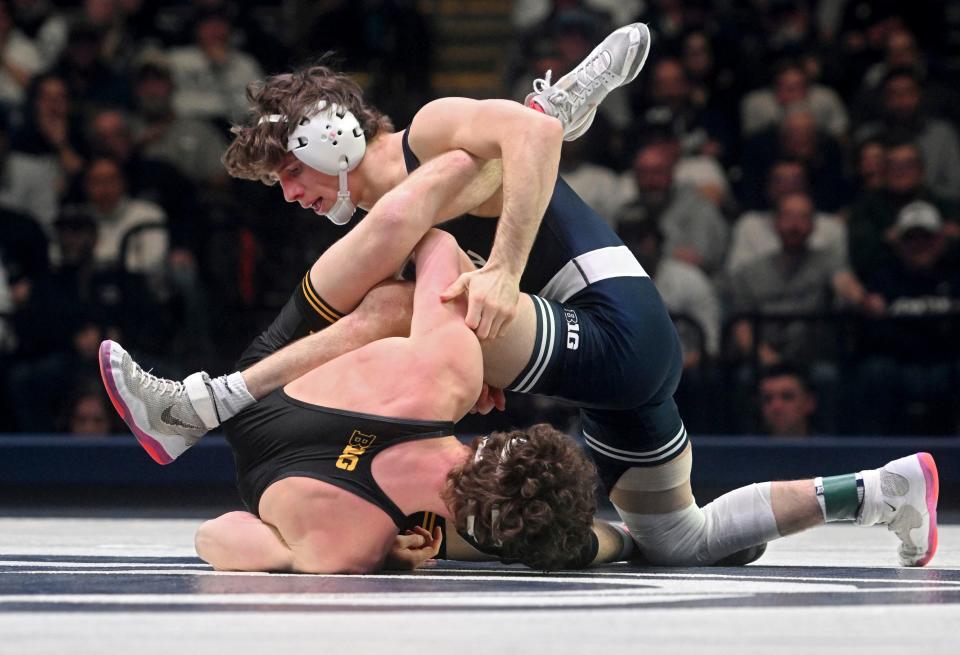 Penn State's Levi Haines, top, wrestles Iowa's Cobe Siebrecht at 157 pounds on Friday, Jan. 27, 2023, in State College, Pa. Haines is 6-0 as a starter this season.