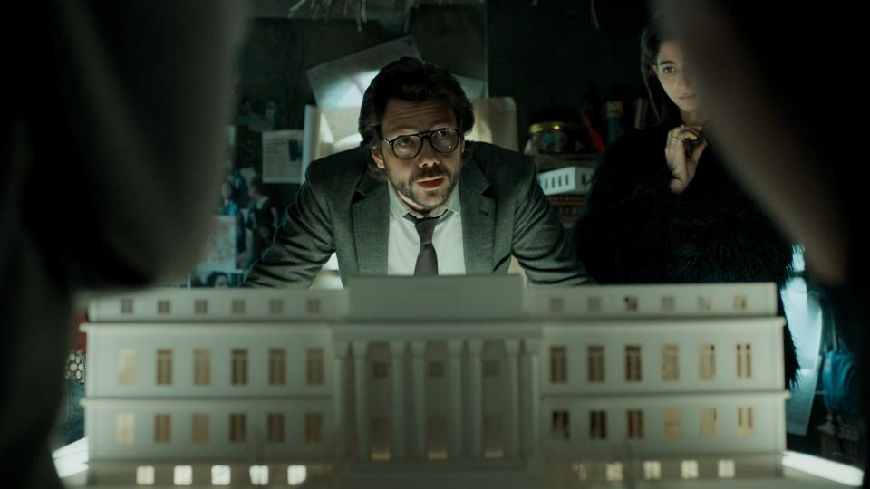 A still from "Money Heist," in which The Professor speaks in front of a model of a building.