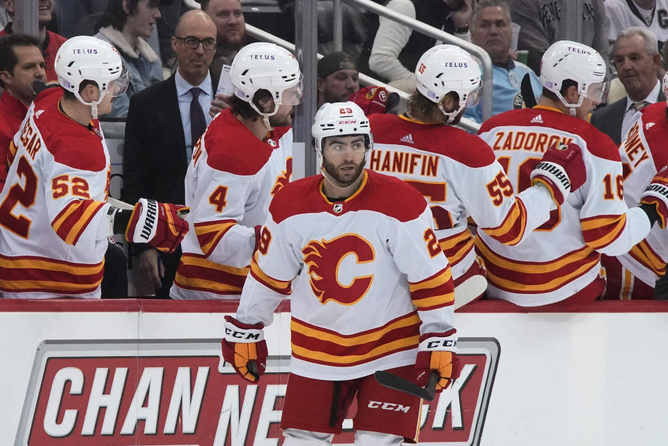 Calgary Flames' Dillon Dube (29) returns to the bench after scoring during the second period of the team's NHL hockey game against the Pittsburgh Penguins in Pittsburgh, Wednesday, Nov. 23, 2022. (AP Photo/Gene J. Puskar)