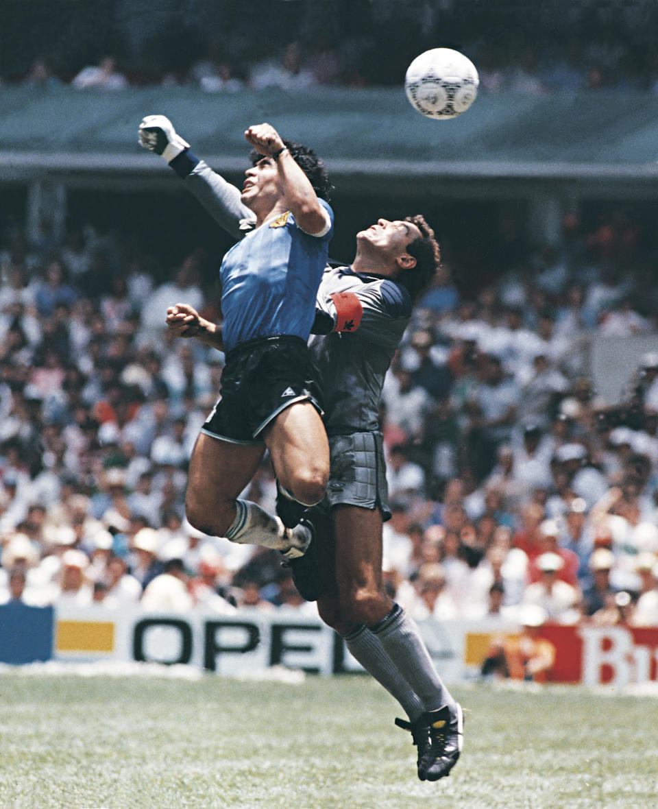 MEXICO CITY, MEXICO - JUNE 22: Diego Maradona of Argentina uses his hand to score the first goal of his team during a 1986 FIFA World Cup Quarter Final match between Argentina and England at Azteca Stadium on June 22, 1986 in Mexico City, Mexico. Maradona later claimed that the goal was scored by 'The Hand Of God'. (Photo by Archivo El Grafico/Getty Images)