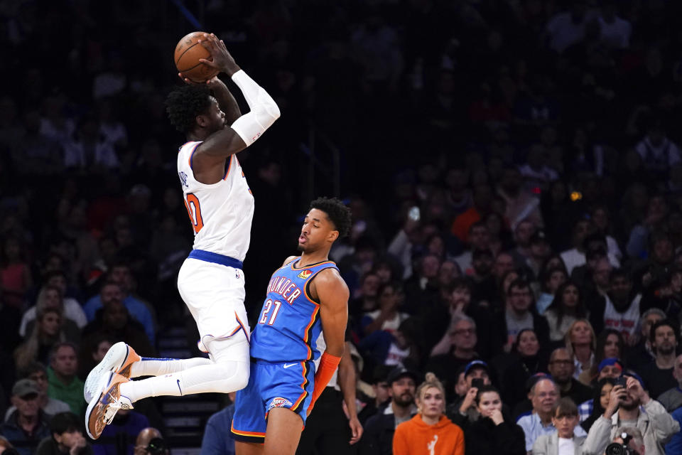 New York Knicks forward Julius Randle (30) jumps against Oklahoma City Thunder guard Aaron Wiggins (21) while passing the ball during the second half of an NBA basketball game, Nov. 13, 2022, in New York. The Thunder won 145-135. (AP Photo/Julia Nikhinson)