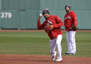 Boston Red Sox's Mookie Betts works out at second base with Dustin Pedroia watching at Fenway Park, Sunday, Oct. 21, 2018, in Boston. The Red Sox are preparing for Game 1 of the baseball World Series against the Los Angeles Dodgers scheduled for Tuesday in Boston. (AP Photo/Elise Amendola)