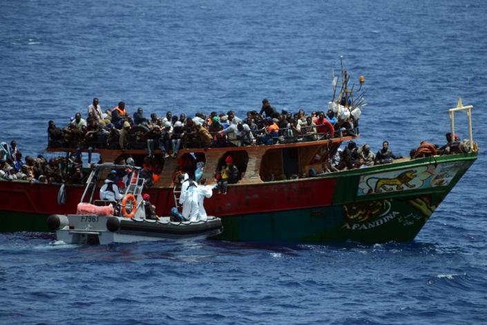 A French Navy patrol ship rescues migrants aboard a fishing boat in the Mediterranean Sea, on May 20, 2015 (AFP Photo/)