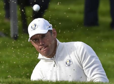 European Ryder Cup player Lee Westwood hits out a bunker on the eighth hole during his fourballs 40th Ryder Cup match at Gleneagles in Scotland September 27, 2014. REUTERS/Toby Melville